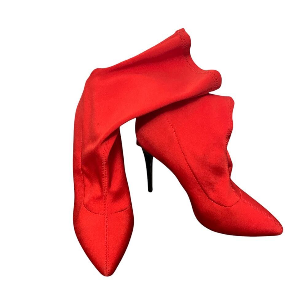 Woman's Bright red, pointed toe, sock boot, black heel. ￼